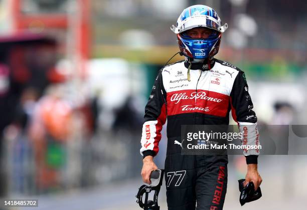 20th place qualifier Valtteri Bottas of Finland and Alfa Romeo F1 walks in the Pitlane during qualifying ahead of the F1 Grand Prix of Belgium at...