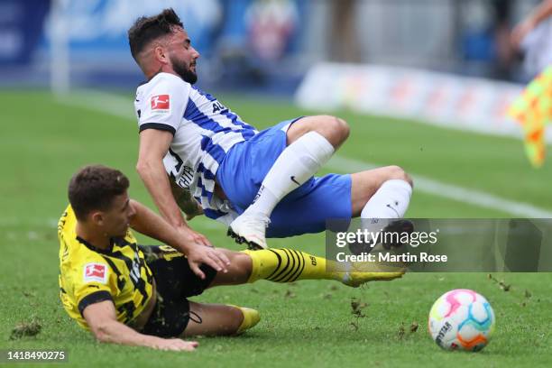 Marco Richter of Hertha Berlin is tackled by Thorgan Hazard of Borussia Dortmund during the Bundesliga match between Hertha BSC and Borussia Dortmund...