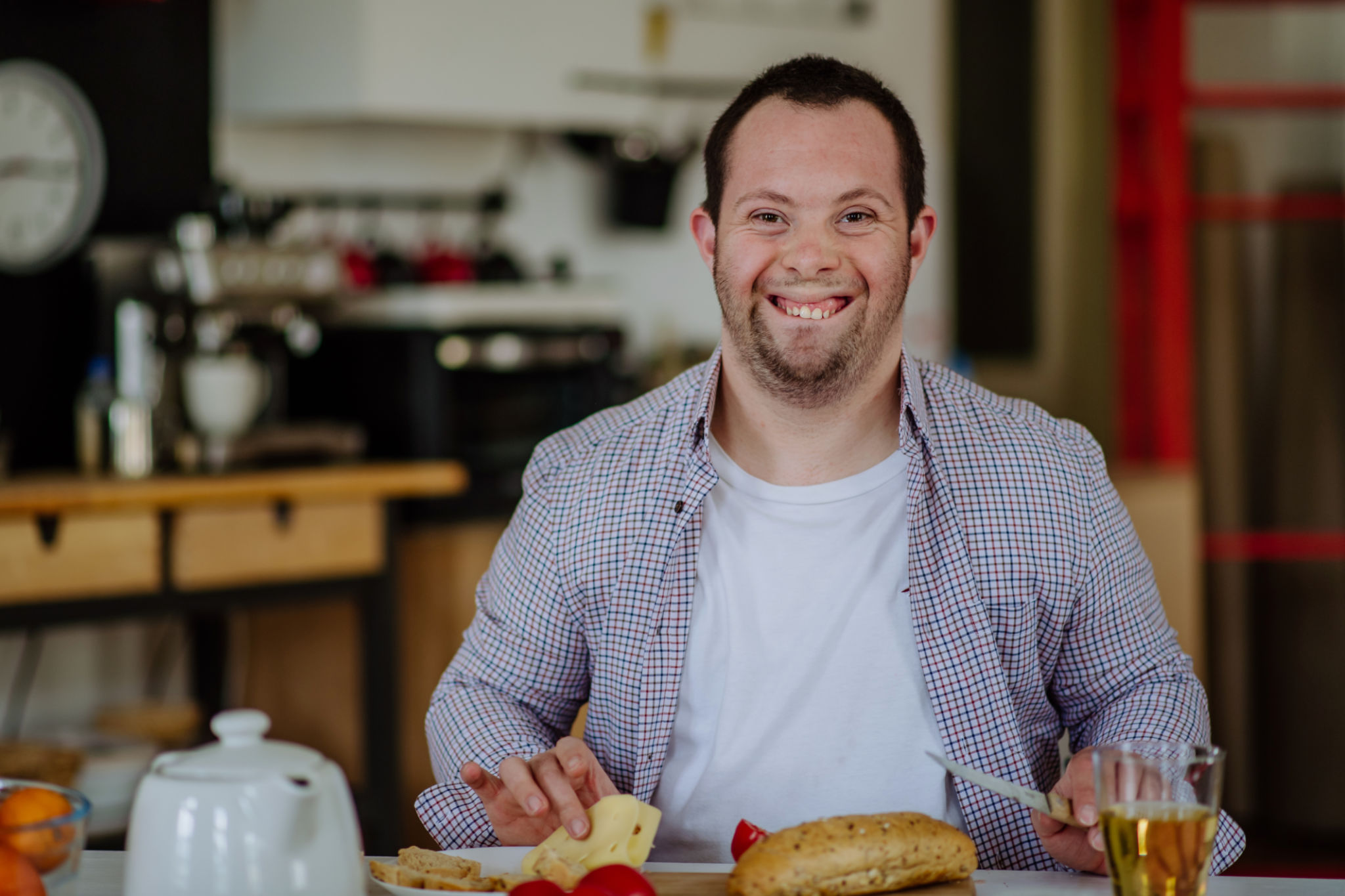 Independent man with down syndrome preparing brekfast in his apartment. Independent man with down syndrome preparing brekfast in his apartment.