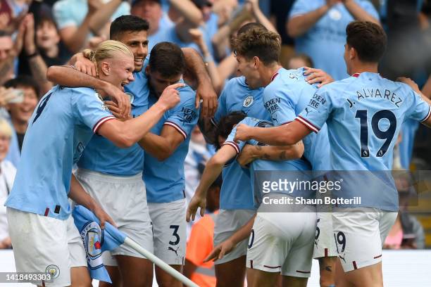Erling Haaland of Manchester City celebrates their sides third goal with team ma during the Premier League match between Manchester City and Crystal...