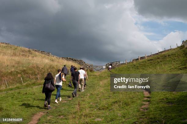 Visitors walk up to a gap in Hadrian's Wall at Cawfields Quarry on August 27, 2022 in Hexham, United Kingdom. 2022 is the 1900 anniversary of the...