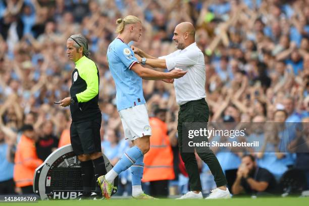 Erling Haaland of Manchester City interacts with Pep Guardiola, Manager of Manchester City during the Premier League match between Manchester City...