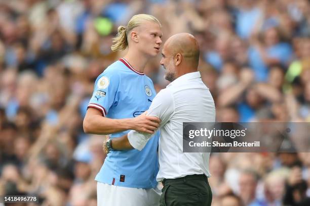 Erling Haaland of Manchester City interacts with Pep Guardiola, Manager of Manchester City during the Premier League match between Manchester City...