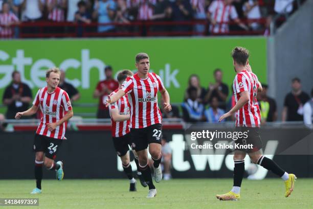 Vitaly Janelt of Brentford celebrates their sides first goal with team mate Mathias Jensen during the Premier League match between Brentford FC and...