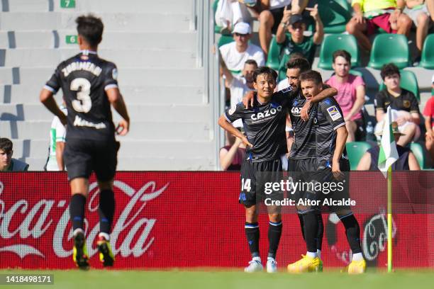 Brais Mendez of Real Sociedad celebrates their sides first goal with team mate Takefusa Kubo during the LaLiga Santander match between Elche CF and...