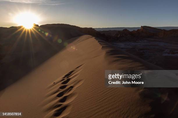 The sun sets over the Valle de la Luna in the Atacama Desert, considered the driest place on earth on August 26, 2022 near San Pedro de Atacama,...