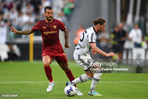 Leonardo Spinazzola of AS Roma battles for possession with Adrien Rabiot of Juventus during the Serie A match between Juventus and AS Roma at Allianz...