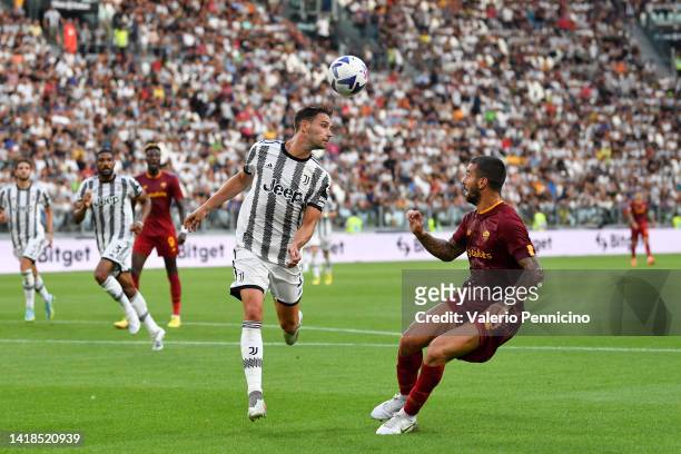 Mattia De Sciglio of Juventus heads the while under pressure from Leonardo Spinazzola of AS Roma during the Serie A match between Juventus and AS...