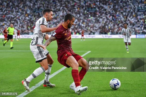 Leonardo Spinazzola of AS Roma holds off Mattia De Sciglio of Juventus during the Serie A match between Juventus and AS Roma at Allianz Stadium on...