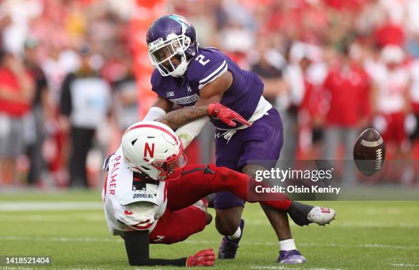 Trey Palmer of Nebraska Cornhuskers is tackled by Cameron Mitchell of Northwestern Wildcats during the game at Aviva Stadium on August 27, 2022 in...