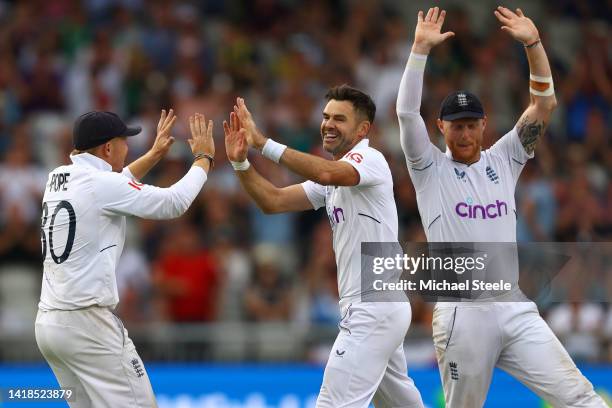 James Anderson celebrates with captain Ben Stokes and Ollie Pope after capturing the wicket of Kagiso Rabada of South Africa during day three of the...