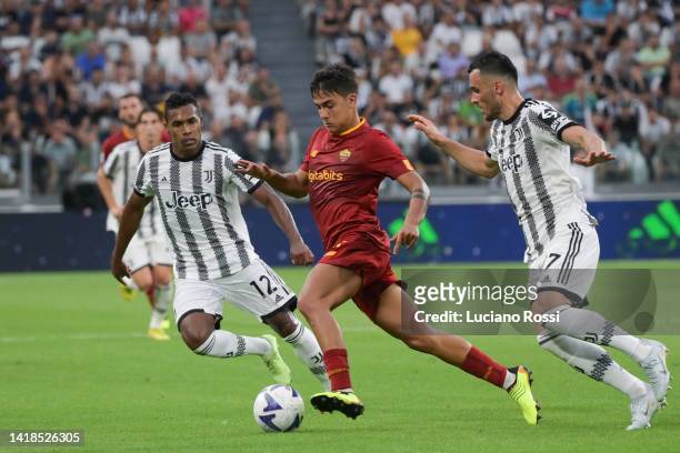 Roma player Paulo Dybala competes with Juventus player Filip Kostic during the Serie A match between Juventus and AS Roma at Allianz Stadium on...