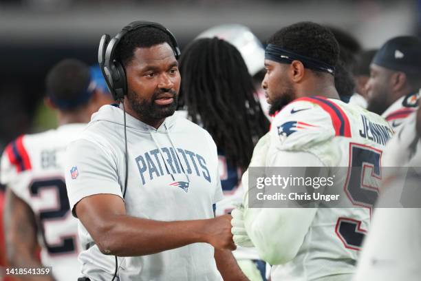 Linebackers coach Jerod Mayo speaks to linebacker Anfernee Jennings of the New England Patriots during the second half of a preseason game at...