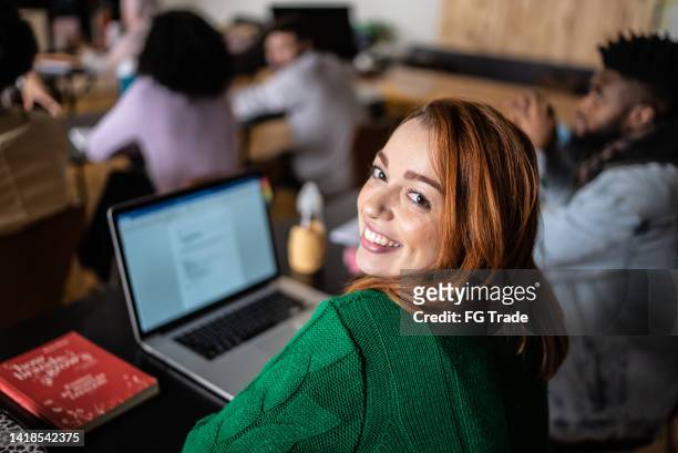 portrait of a young woman in the classroom - online classroom stock pictures, royalty-free photos & images