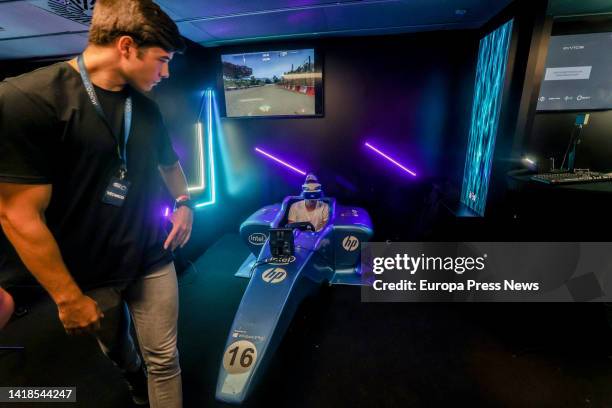 Cryptocurrency event attendees enjoy the virtual reality video games installed at the event, at the WiZink Center, on August 26 in Madrid, Spain. The...