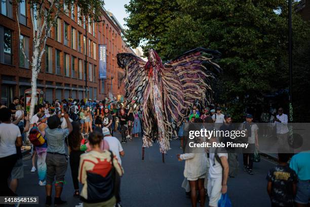 Stilt-walker is seen the evening before the start of Notting Hill Carnival on August 27, 2022 in London, England. The Caribbean carnival returns to...