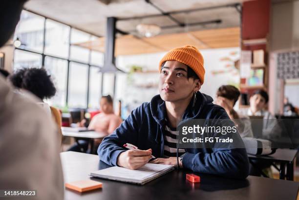 young man during class in the university - universitetsstudent bildbanksfoton och bilder