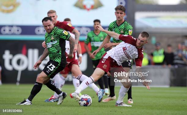 Marc Leonard of Northampton Town looks to control the ball with Lee Tomlin of Doncaster Rovers during the Sky Bet League Two between Northampton Town...