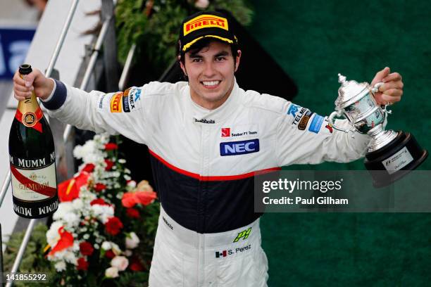 Sergio Perez of Mexico and Sauber F1 celebrates on the podium after finishing second during the Malaysian Formula One Grand Prix at the Sepang...