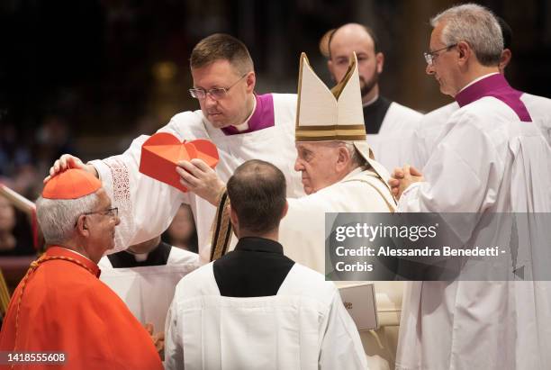 Newly appointed Cardinal Adalberto Martinez Flores receives the red hat, biretta, from Pope Francis during an extraordinary consistory for the...