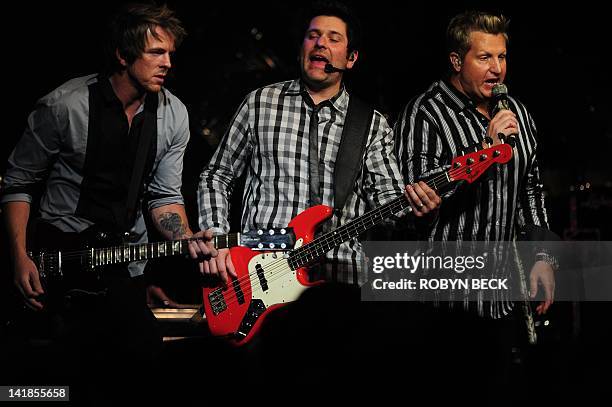 Joe Don Rooney , Jay DeMarcus and Gary LeVox of the group Rascal Flatts perform on stage at Muhammad Ali's Celebrity Fight Night XVIII on March 24,...