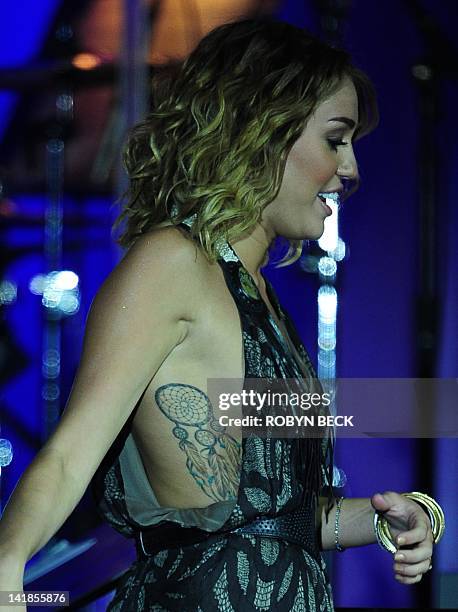 Miley Cyrus performs on stage at Muhammad Ali's Celebrity Fight Night XVIII on March 24, 2012 in Phoenix, Arizona. The event supports the fight...