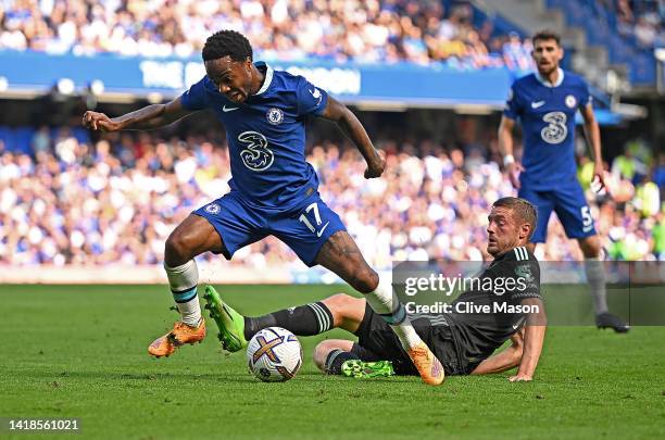 Raheem Sterling of Chelsea is tackled by Jamie Vardy of Leicester City during the Premier League match between Chelsea FC and Leicester City at...