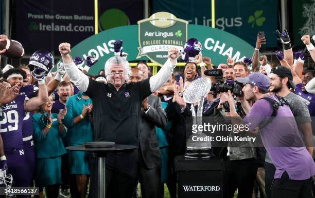 Northwestern Wildcats head coach, Pat Fitzgerald celebrates with a glass helmet after the Aer Lingus College Football Classic 2022 match between...