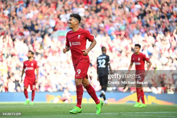 Roberto Firmino of Liverpool celebrates after scoring their team's seventh goal during the Premier League match between Liverpool FC and AFC...