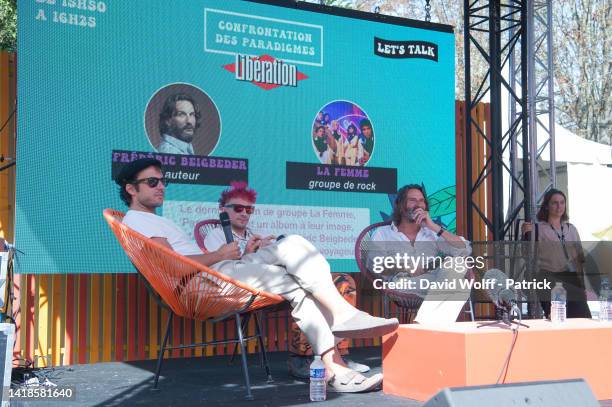 Sacha Got and Marlon Magnée of La Femme speak with Frédéric Beigbeder during Rock en Seine Festival on August 27, 2022 in Saint-Cloud, France.