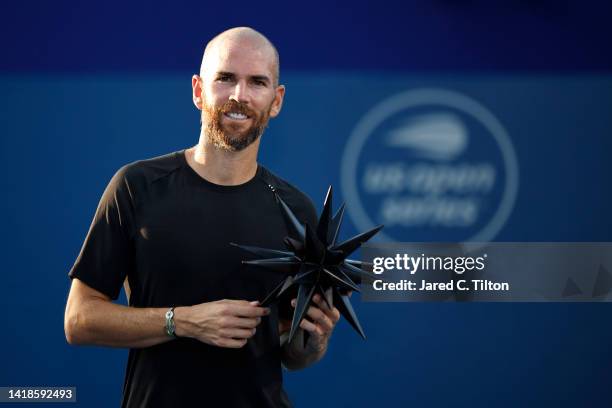 Adrian Mannarino of France poses with the trophy after defeating Laslo Djere of Serbia in the men's singles championship final on day eight of the...