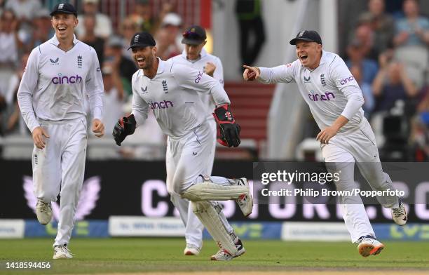 Ollie Pope , Ben Foakes and Zak Crawley of England celebrate after the dismissal of Keshav Maharaj of South Africa during the third day of the second...