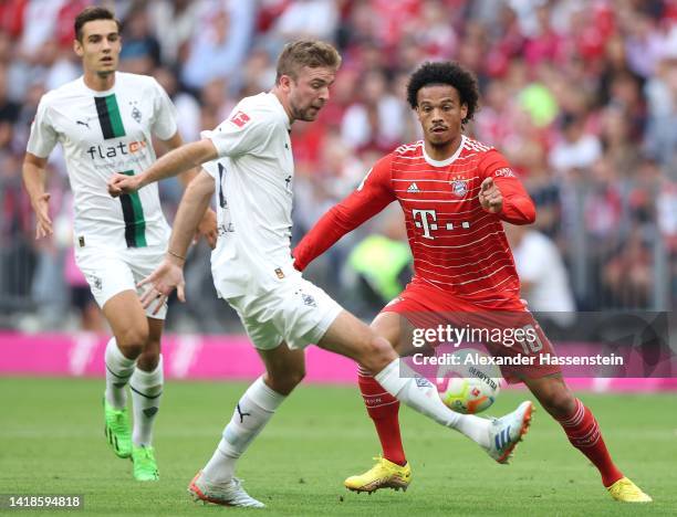 Leroy Sane of Bayern Munich is put under pressure by Christoph Kramer of Borussia Monchengladbach during the Bundesliga match between FC Bayern...