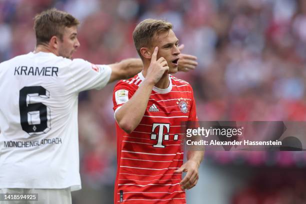Joshua Kimmich of Bayern Munich reacts with Christoph Kramer of Borussia Monchengladbach during the Bundesliga match between FC Bayern München and...