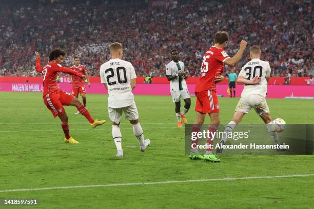 Leroy Sane of Bayern München scores their team's first goal past Yann Sommer of Borussia Monchengladbach during the Bundesliga match between FC...