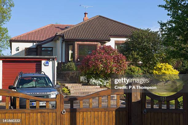 bungalow front garden, gates and drive with car parked, wirral, merseyside, england - driving by houses stock pictures, royalty-free photos & images