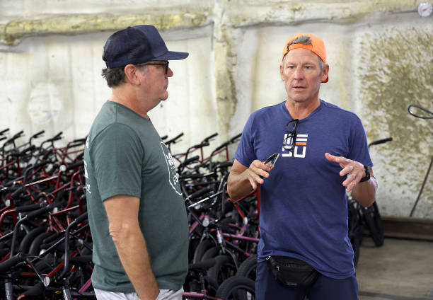 Hagar speaks with Lance Armstrong in front of 800 bikes to be donated to students and families of Robb Elementary and Flores Elementary schools...