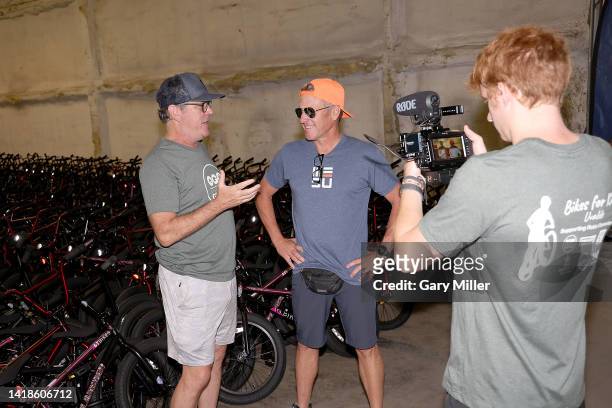 Hagar speaks with Lance Armstrong in front of 800 bikes to be donated to students and families of Robb Elementary and Flores Elementary schools...
