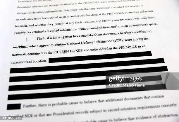 In this photo illustration, a page is viewed from the government’s released version of the F.B.I. Search warrant affidavit for former President...