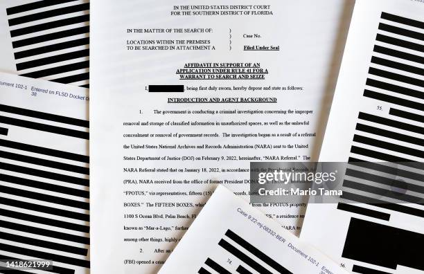 In this photo illustration, pages are viewed from the government’s released version of the F.B.I. Search warrant affidavit for former President...