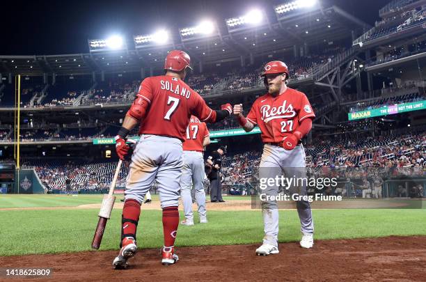 Jake Fraley of the Cincinnati Reds celebrates with Donovan Solano after scoring in the ninth inning against the Washington Nationals at Nationals...