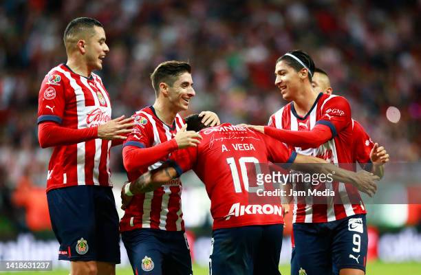 Alexis Vega of Chivas celebrates with teammates after scoring his team's second goal during the 11th round match between Chivas and Pumas UNAM as...