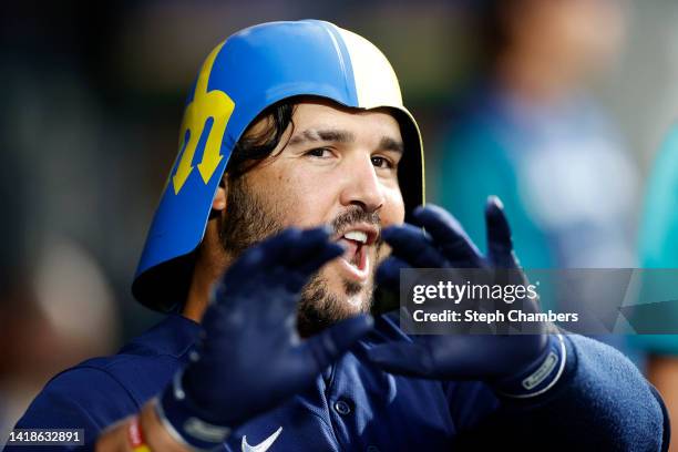 Eugenio Suarez of the Seattle Mariners celebrates in the dugout after his home run during the second inning against the Cleveland Guardians at...