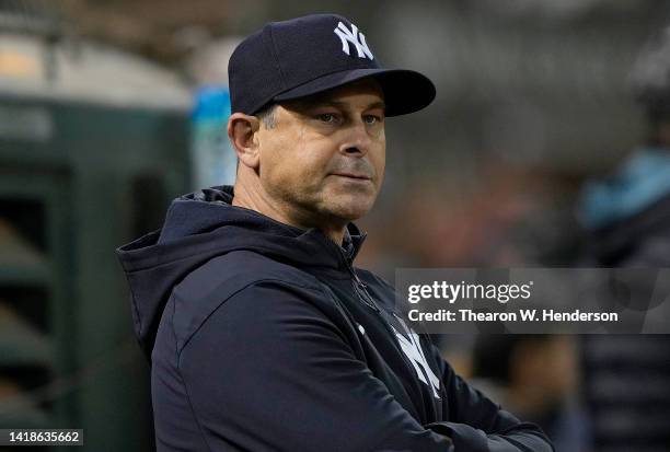 Aaron Boone of the New York Yankees looks down into his bullpen against the Oakland Athletics in the bottom of the eighth inning at RingCentral...