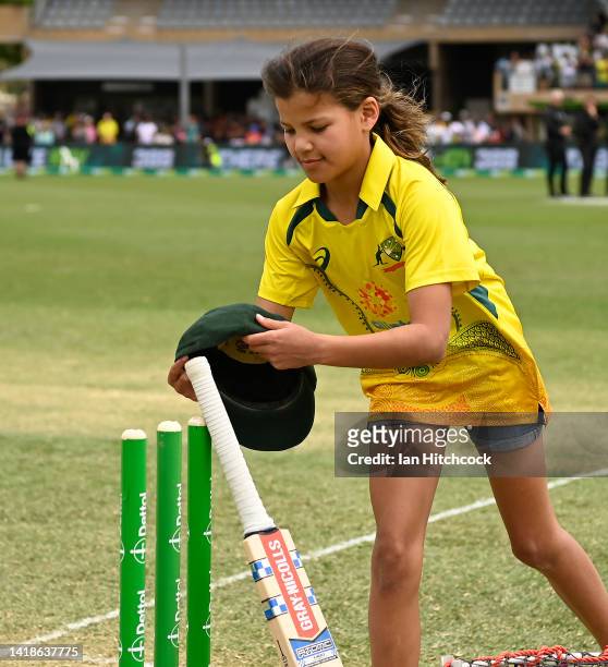Chloe Symonds the daughter of former Australian Cricketer Andrew Symonds places his 'Baggy Green' cap on the stumps during a memorial ceremony during...