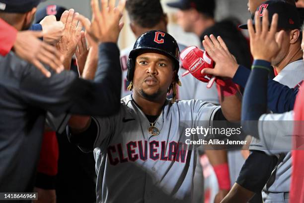 Jose Ramirez of the Cleveland Guardians celebrates in the dugout with teammates after hitting a solo home run during the fourth inning against the...