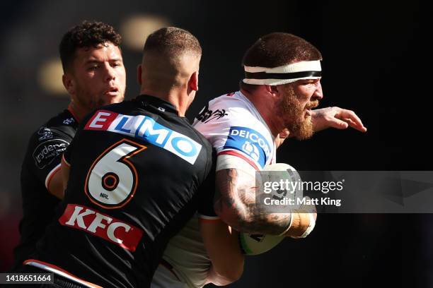 Josh McGuire of the Dragons is tackled during the round 24 NRL match between the Wests Tigers and the St George Illawarra Dragons at CommBank...