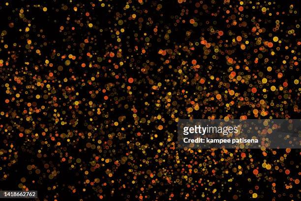drops of orange red and yellow paint on a black background - 大量 ストックフォトと画像