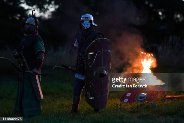 Roman soldier re-enactors form up after fighting with the Barbarians during a night attack at Chesters Roman Fort on August 27, 2022 in Hexham,...