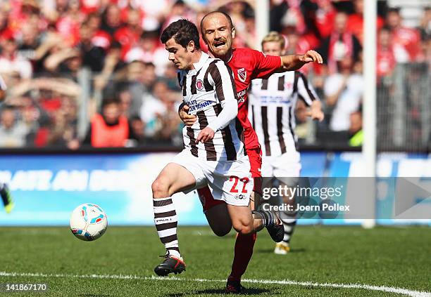 Fin Bartels of St. Pauli and Ivica Banovic of Cottbus battle for the ball during the Second Bundesliga match between St. Pauli and Energie Cottbus at...